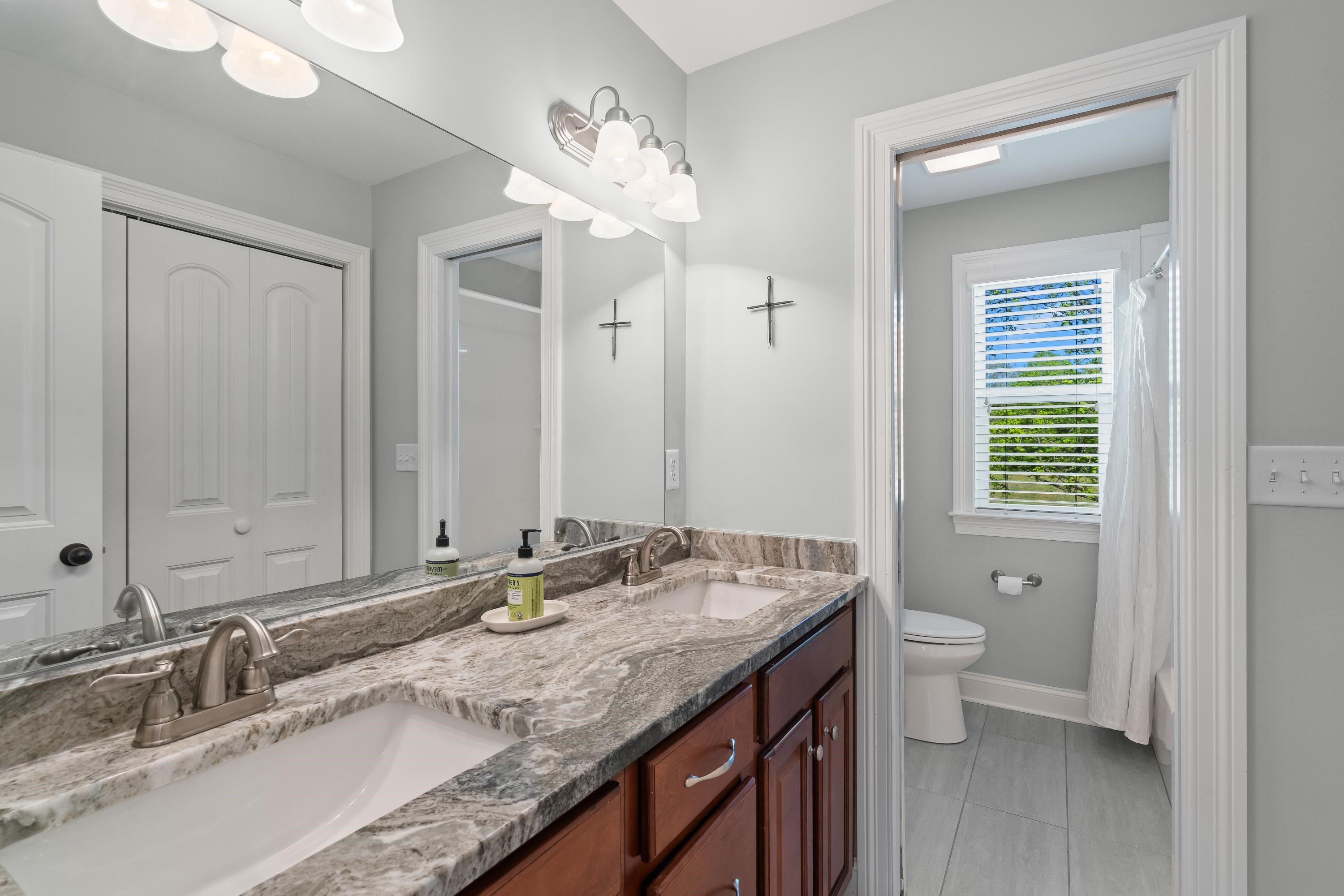 210 Poplar Acres Road Piperton, TN 38017 - Photo 27 of 40 a bathroom with a granite countertop double vanity sink a mirror and a