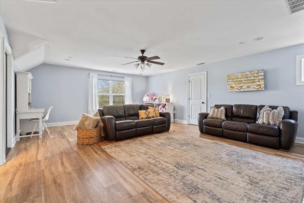 210 Poplar Acres Road Piperton, TN 38017 - Photo 31 of 40 a living room with furniture and a wooden floor