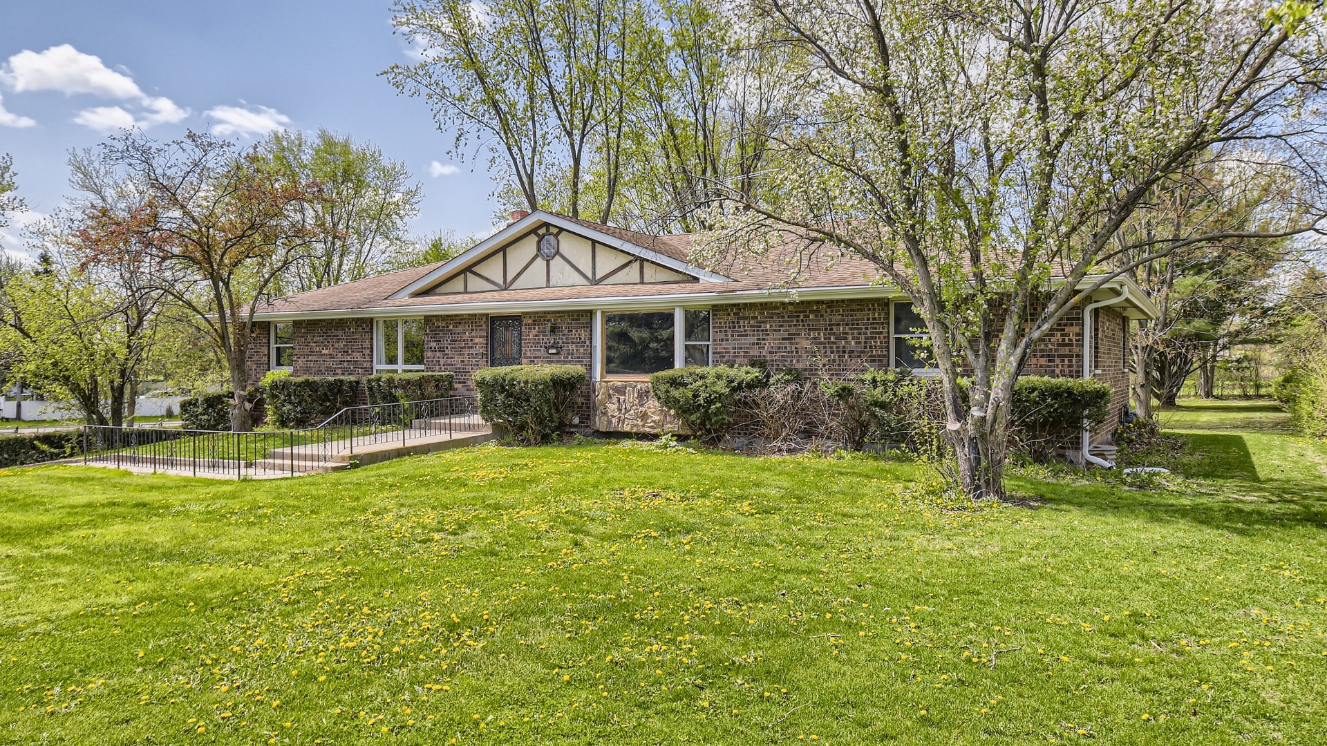 a front view of a house with a yard table and chairs