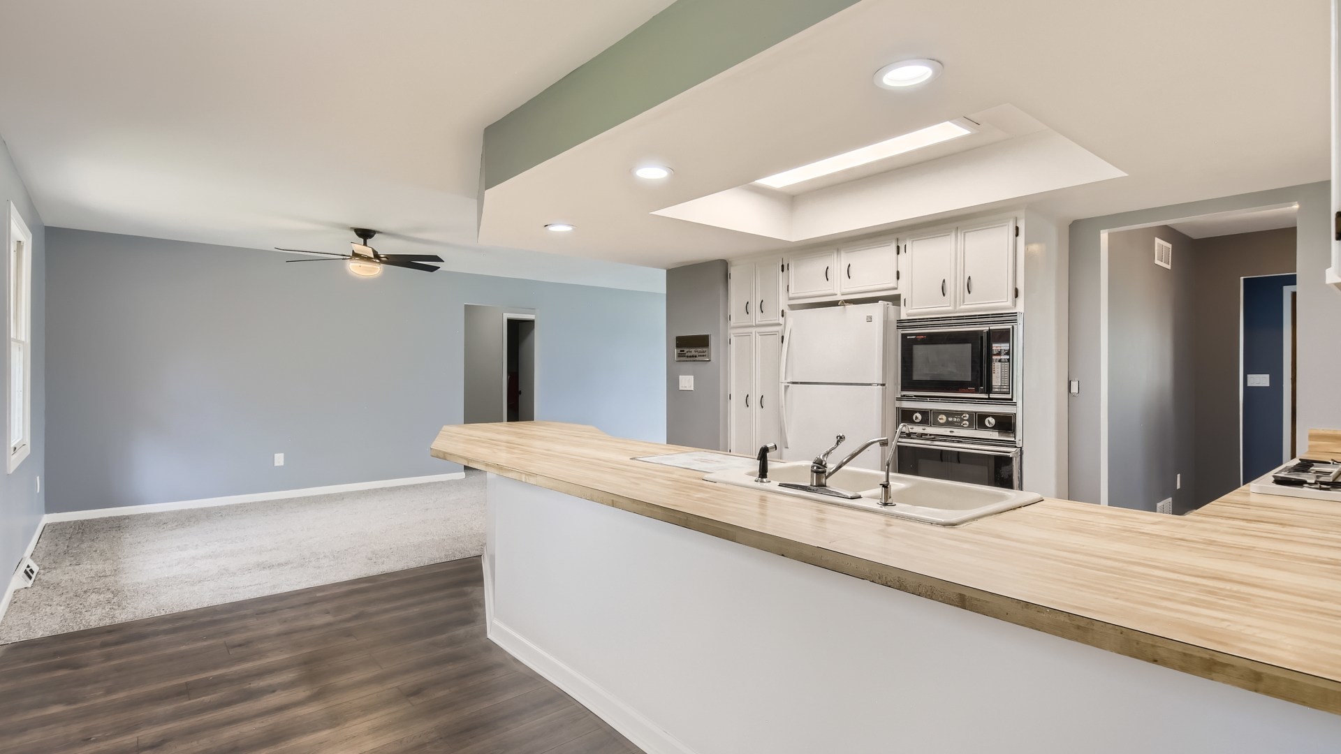 16156 Weber Road Crest Hill, IL 60403 - Photo 11 of 39 a large kitchen with kitchen island a sink stainless steel appliances and cabinets