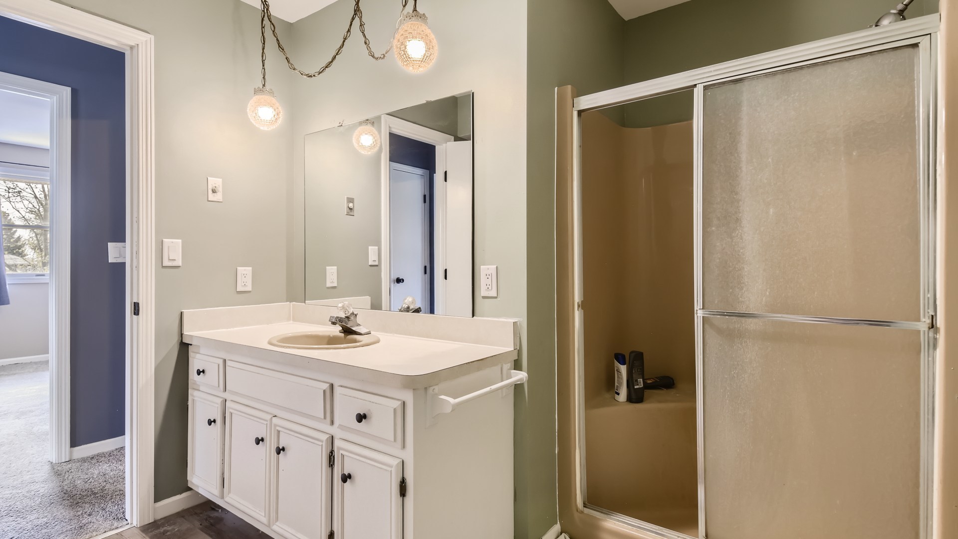 16156 Weber Road Crest Hill, IL 60403 - Photo 22 of 39 a bathroom with a shower sink vanity and mirror