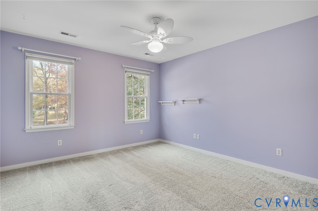 1918 Castle Glen Drive Chesterfield, VA 23236 - Photo 17 of 33 an empty room with windows and chandelier fan