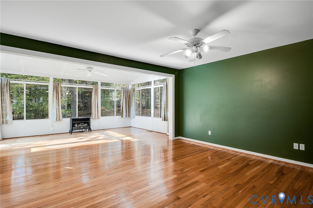 1918 Castle Glen Drive Chesterfield, VA 23236 - Photo 6 of 33 a view of an empty room with a window and wooden floor
