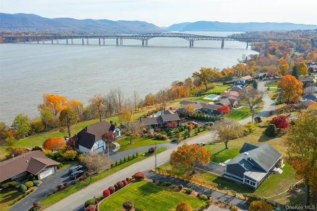 an aerial view of lake and residential houses with outdoor space