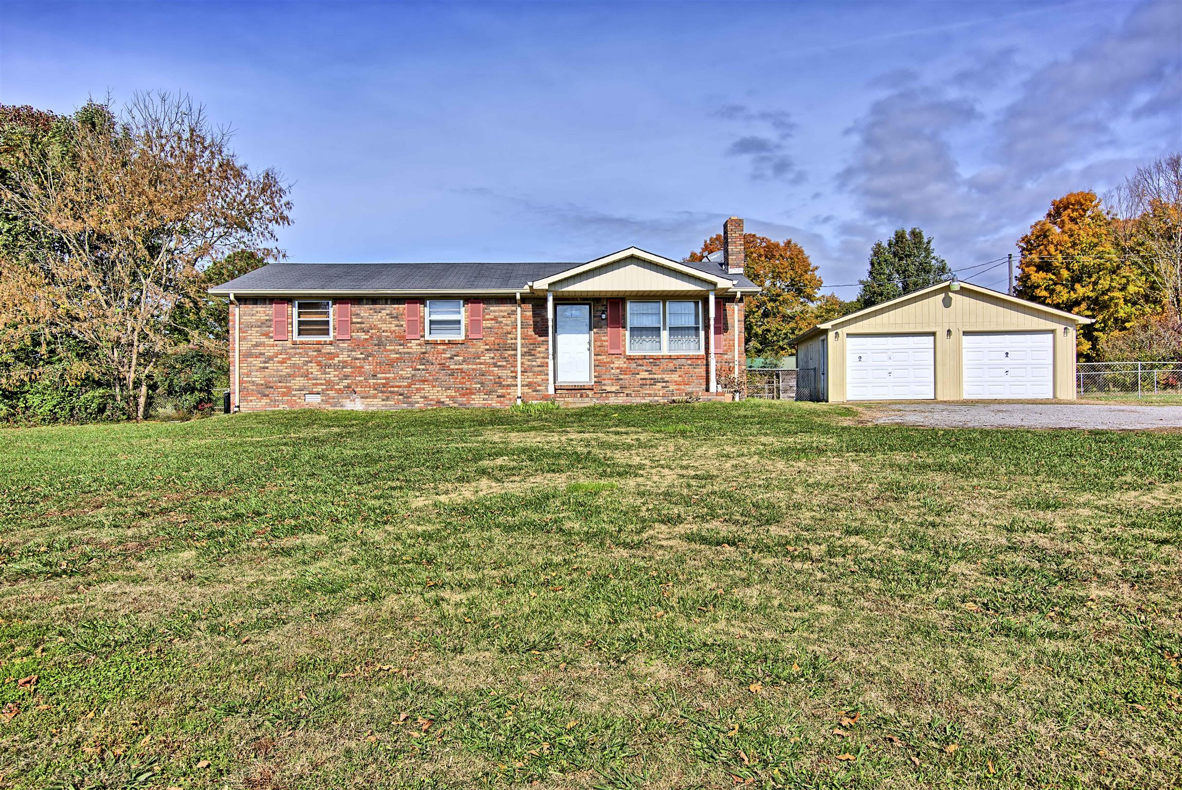 7487 Deer Ridge Road Primm Springs, TN 38476 - Photo 1 of 13 a front view of a house with a yard