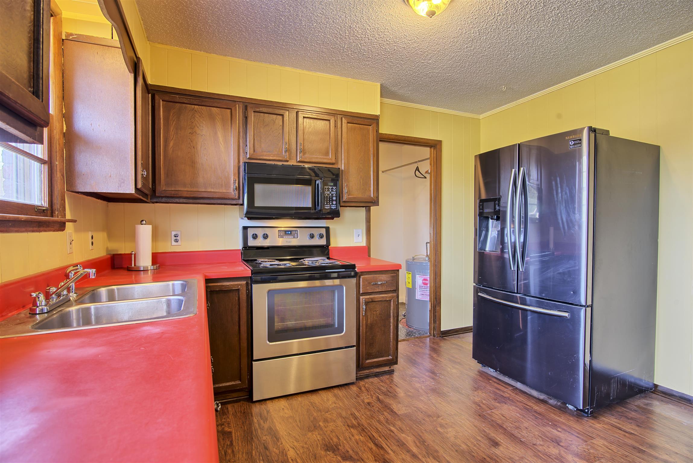 7487 Deer Ridge Road Primm Springs, TN 38476 - Photo 5 of 13 a kitchen with stainless steel appliances granite countertop a refrigerator stove and sink