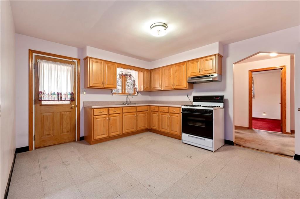663 Loretta Street Pittsburgh, PA 15217 - Photo 6 of 17 a kitchen with stainless steel appliances a stove sink and cabinets