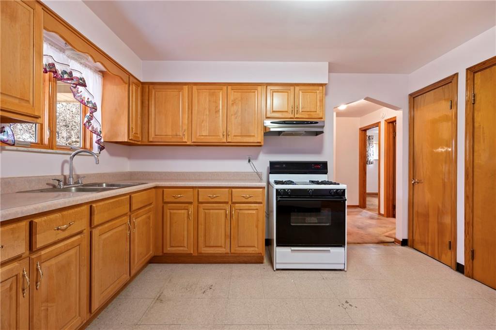 663 Loretta Street Pittsburgh, PA 15217 - Photo 7 of 17 a kitchen with stainless steel appliances granite countertop a stove a sink and a refrigerator