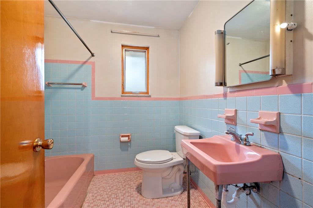 663 Loretta Street Pittsburgh, PA 15217 - Photo 9 of 17 a bathroom with a sink a toilet and a mirror