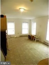 a view of a room with window and furniture