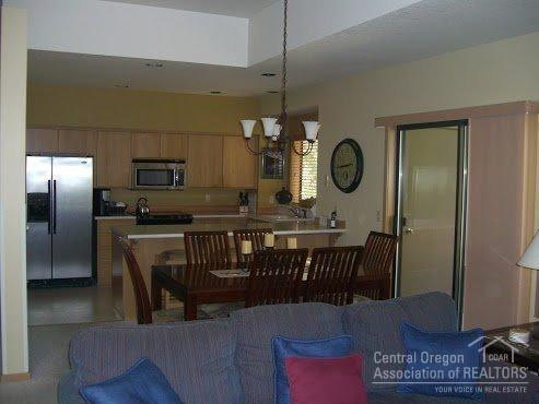 57395 Beaver Ridge Loop, Unit 40 A1 Sunriver, OR 97707 - Photo 6 of 25 a kitchen with a refrigerator a sink and cabinets
