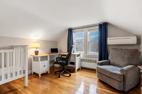 a room with a chair and wooden floor