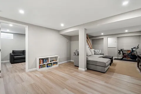 a living room with furniture a flat screen tv and white walls