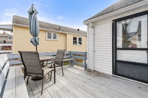 a view of a chairs and table in backyard