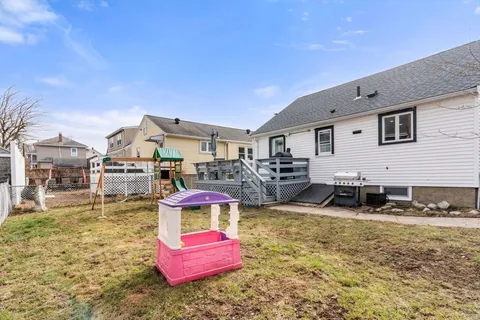 a view of a house with wooden fence