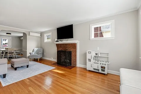 a living room with furniture fireplace and flat screen tv