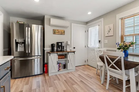 a kitchen with stainless steel appliances a refrigerator and wooden floor