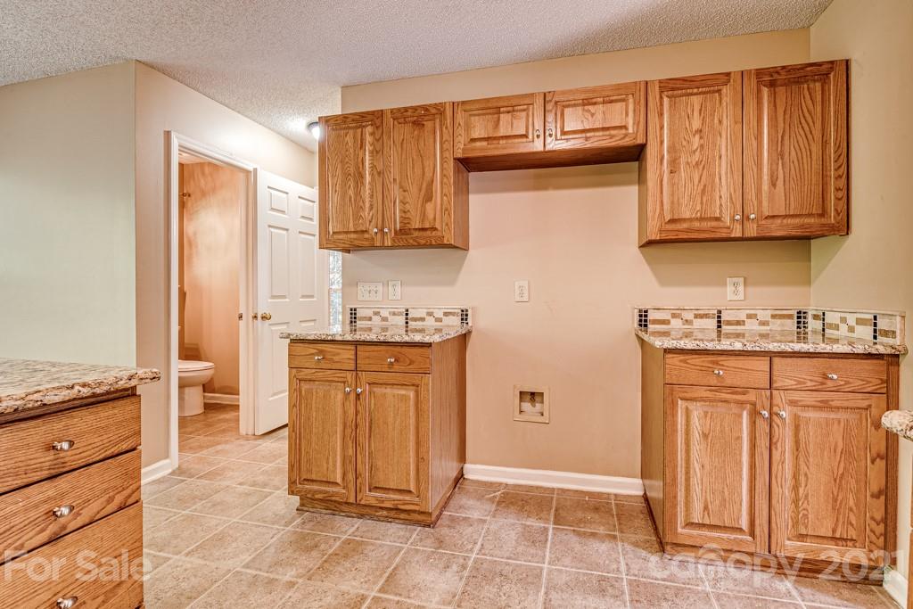 4516 Brownes Ferry Road Charlotte, NC 28269 - Photo 12 of 32 a kitchen with stainless steel appliances granite countertop a refrigerator and cabinets