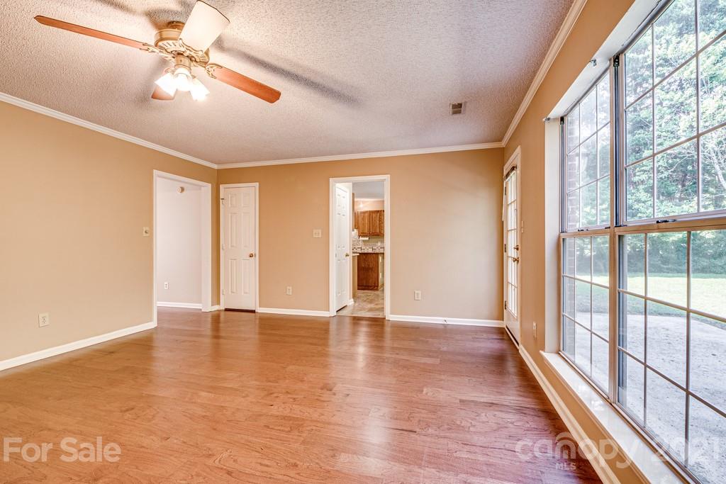 4516 Brownes Ferry Road Charlotte, NC 28269 - Photo 14 of 32 a view of an empty room with window and chandelier fan
