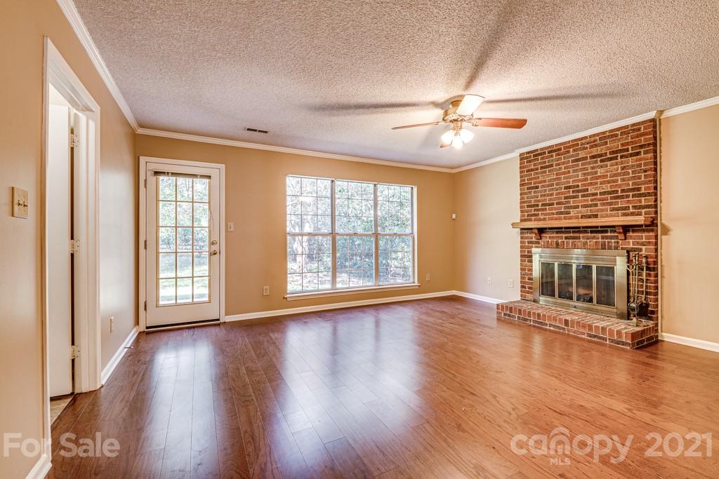 4516 Brownes Ferry Road Charlotte, NC 28269 - Photo 15 of 32 a view of an empty room with wooden floor and a window