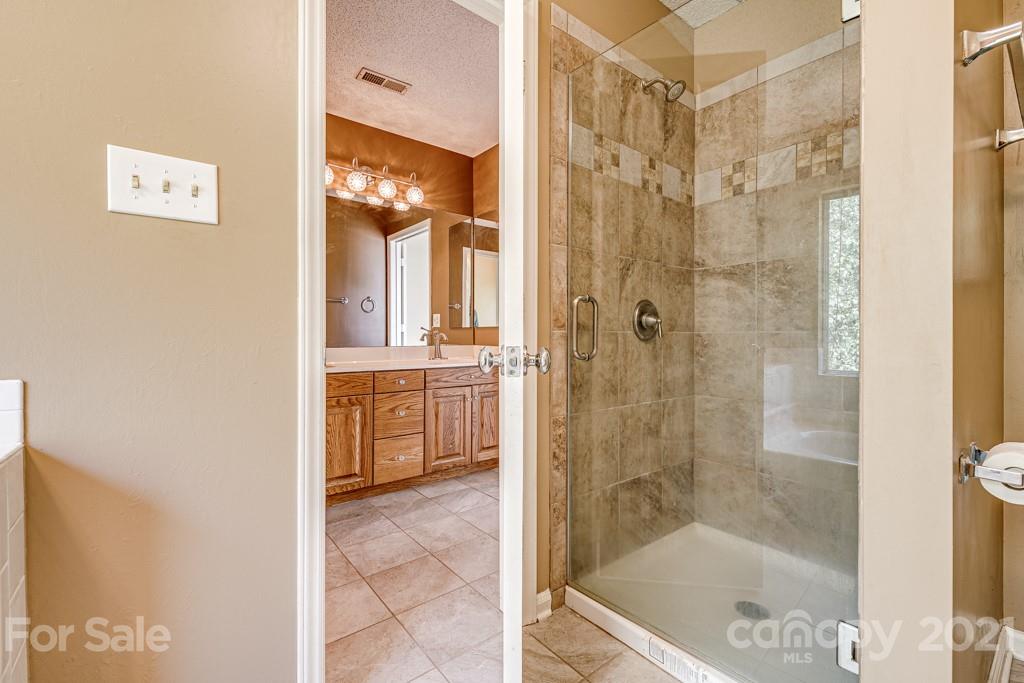 4516 Brownes Ferry Road Charlotte, NC 28269 - Photo 22 of 32 a bathroom with a bath tub and shower