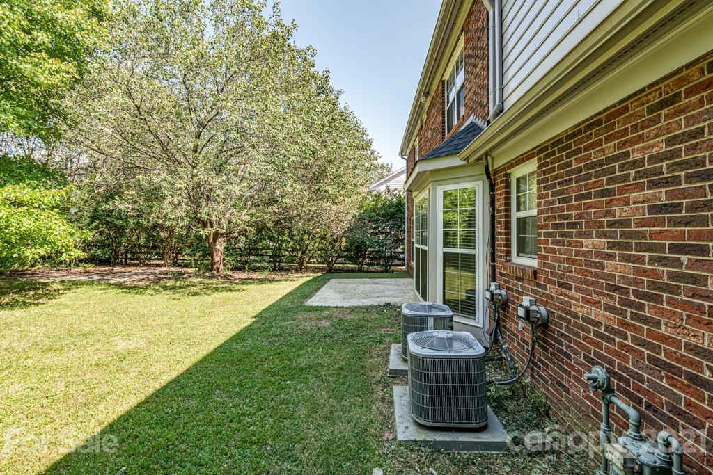4516 Brownes Ferry Road Charlotte, NC 28269 - Photo 30 of 32 a view of a house with backyard and sitting area