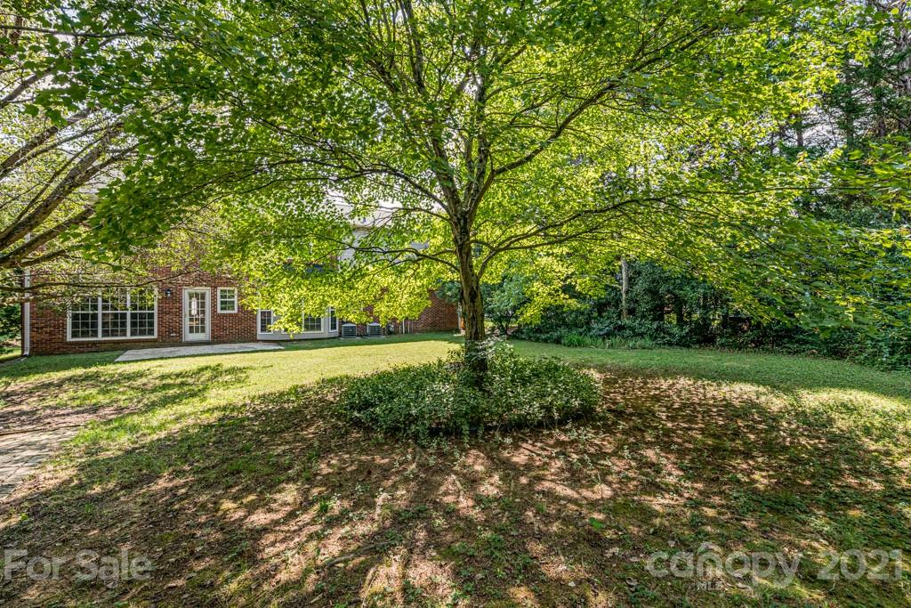 4516 Brownes Ferry Road Charlotte, NC 28269 - Photo 32 of 32 a view of a house with a yard