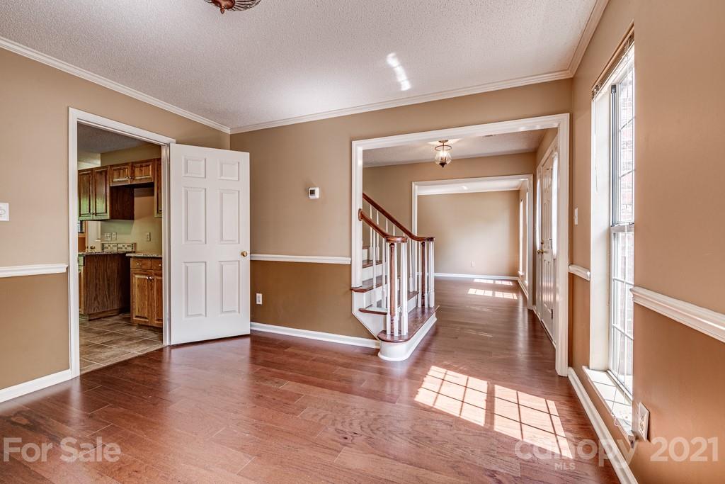 4516 Brownes Ferry Road Charlotte, NC 28269 - Photo 5 of 32 a view of entryway with stairs and wooden floor