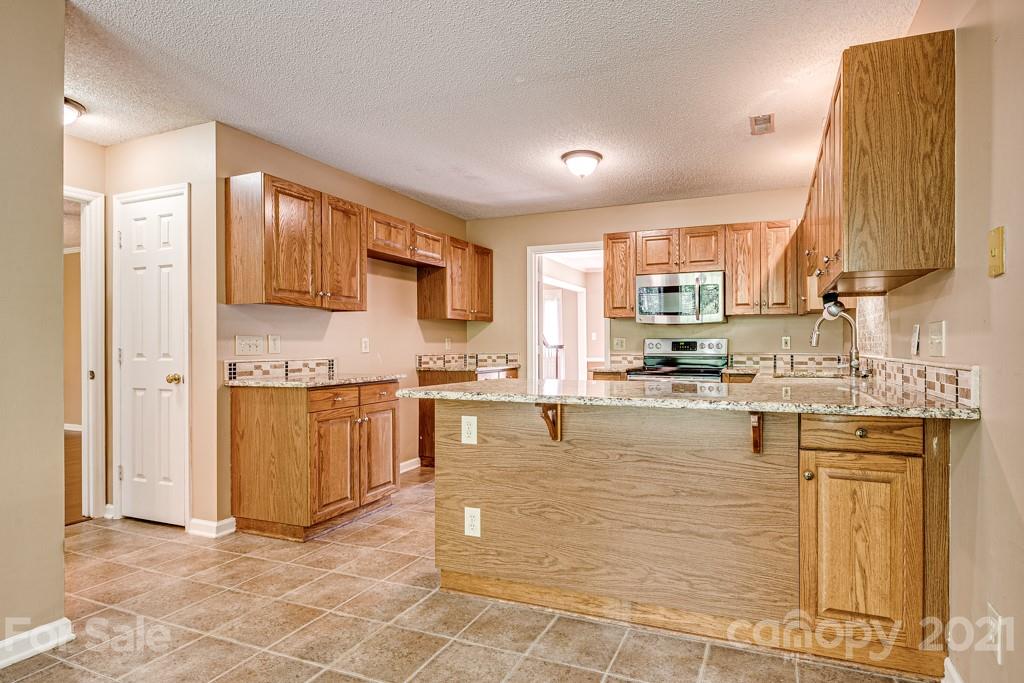 4516 Brownes Ferry Road Charlotte, NC 28269 - Photo 10 of 32 a large kitchen with cabinets