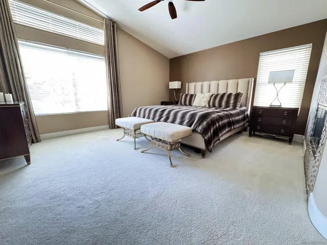 a spacious bedroom with a bed and a couch