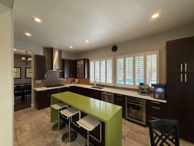 a large kitchen with a table and chairs in it