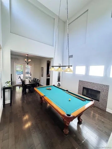 a room with pool tables and windows