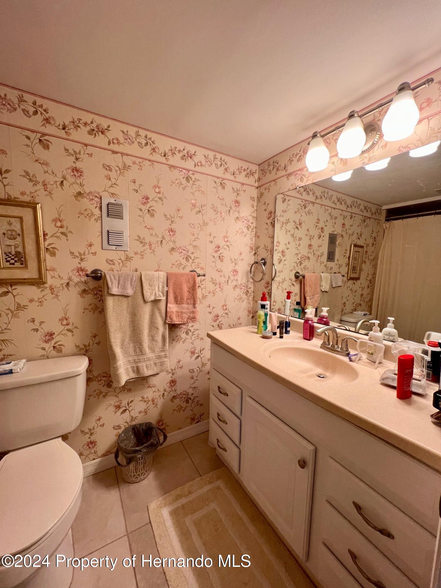 4660 Marine Parkway New Port Richey, FL 34652 - Photo 15 of 18 a bathroom with a toilet sink and mirror