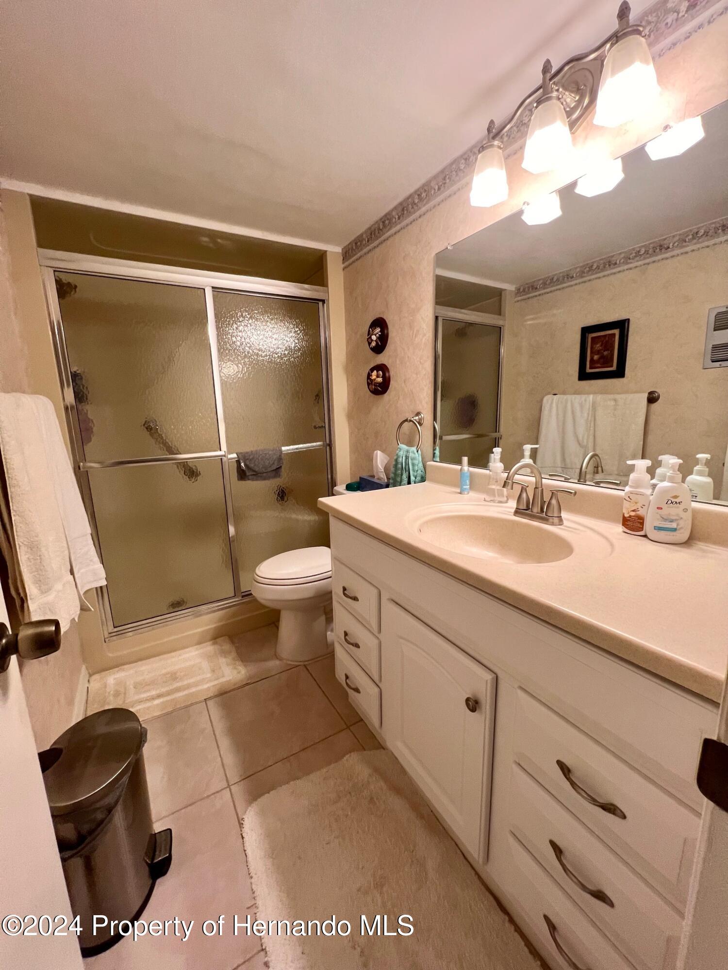 4660 Marine Parkway New Port Richey, FL 34652 - Photo 17 of 18 a bathroom with a double vanity sink mirror and toilet
