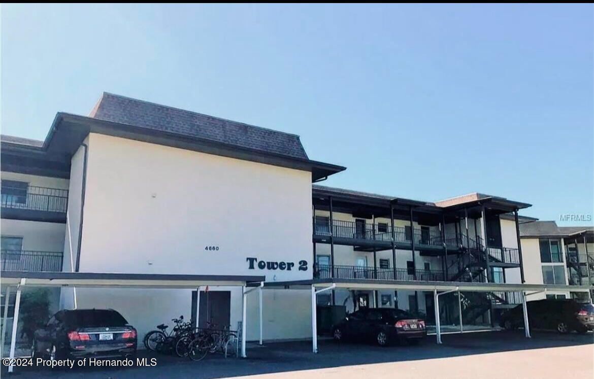4660 Marine Parkway New Port Richey, FL 34652 - Photo 2 of 18 a room with lots of furniture and clutter