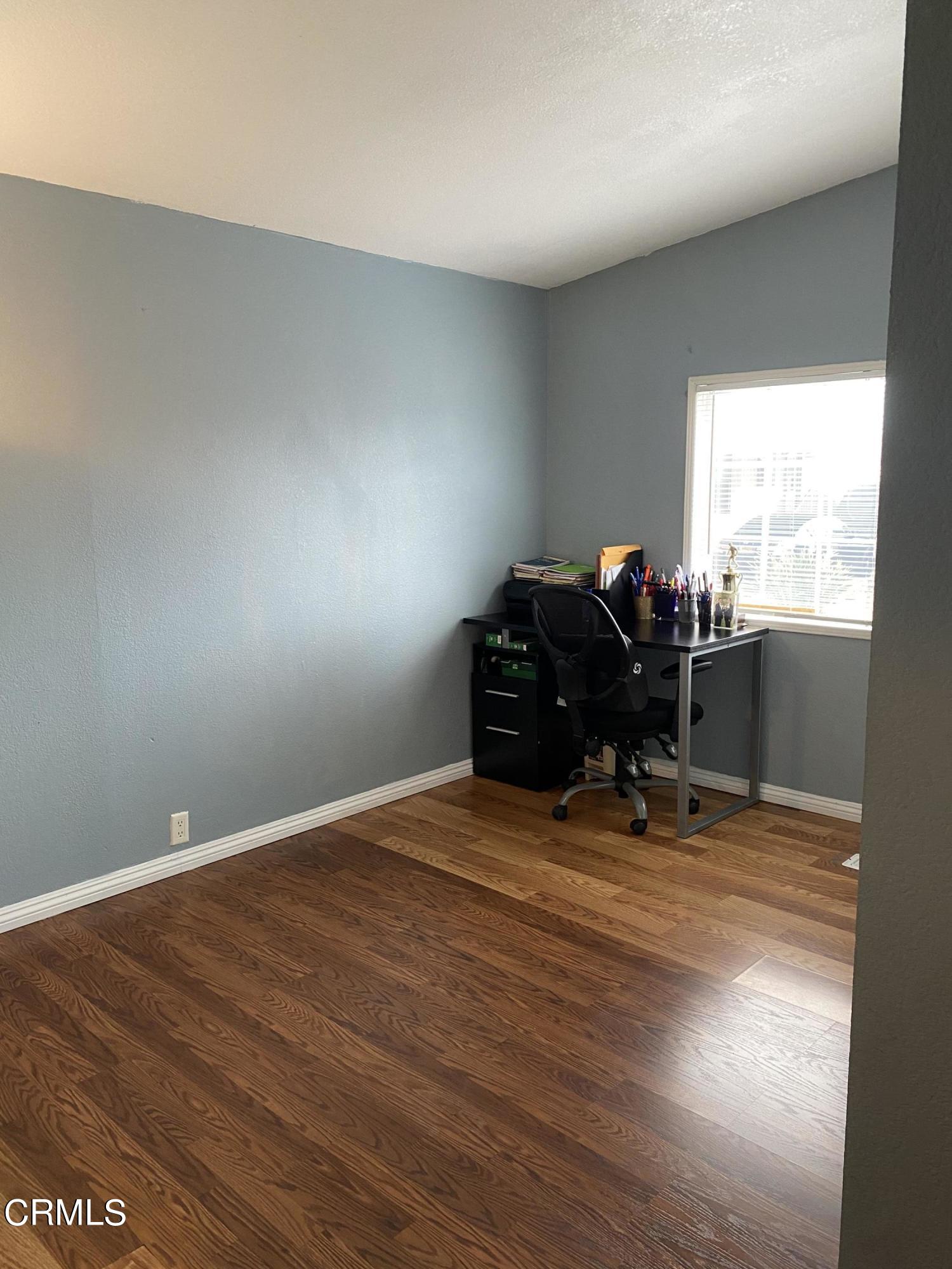 1853 Ives Avenue, Unit 151 Oxnard, CA 93033 - Photo 3 of 11 a workspace with furniture and window