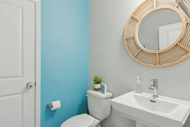 a front view of a house with a garden and garage