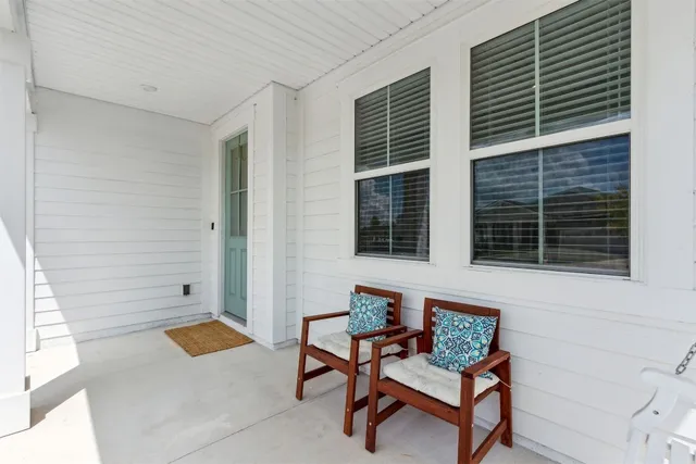 a living room with furniture and view of kitchen