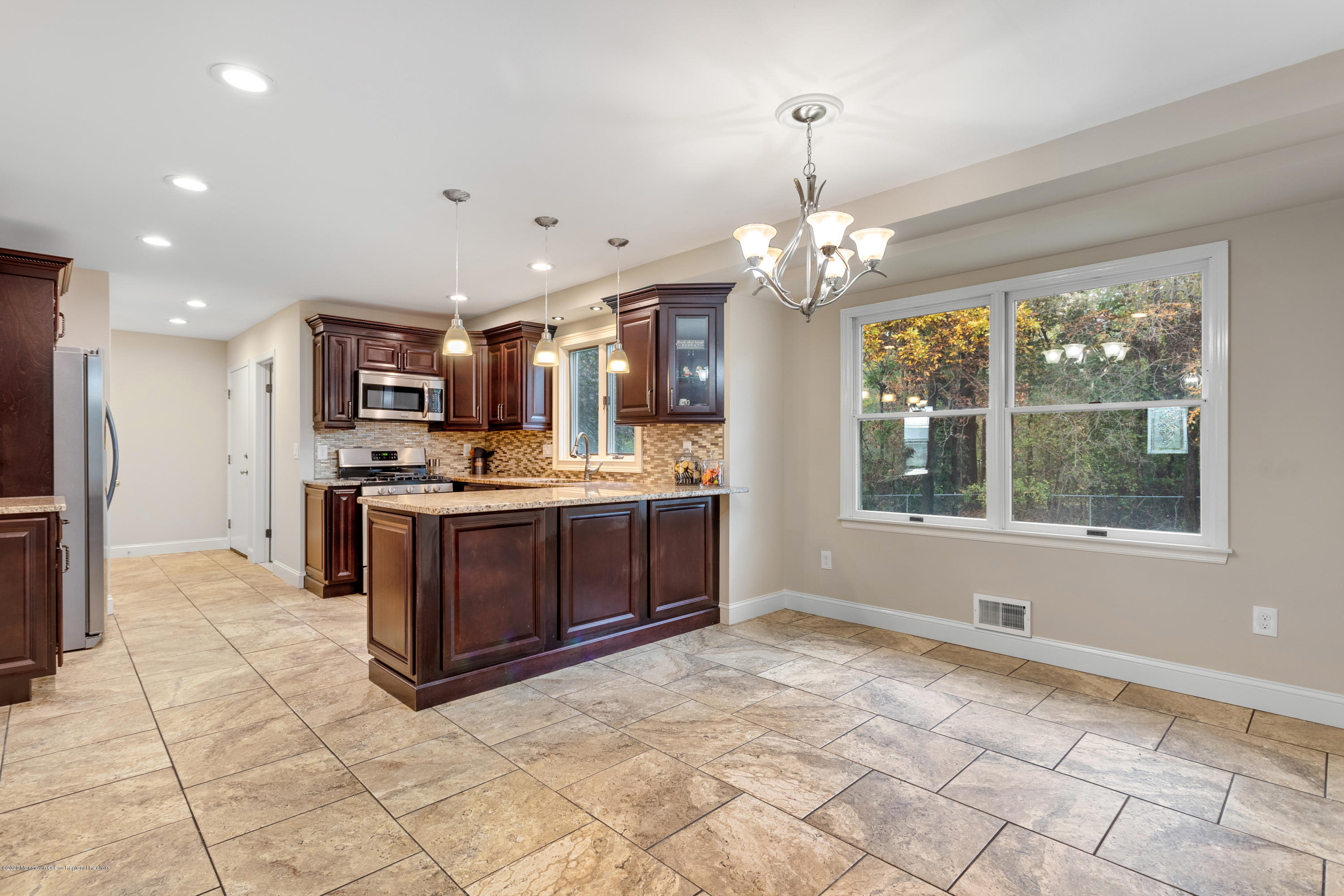 202 Adelphia Road Farmingdale, NJ 07727 - Photo 11 of 40 a open kitchen with kitchen island granite countertop a refrigerator oven a sink and dishwasher