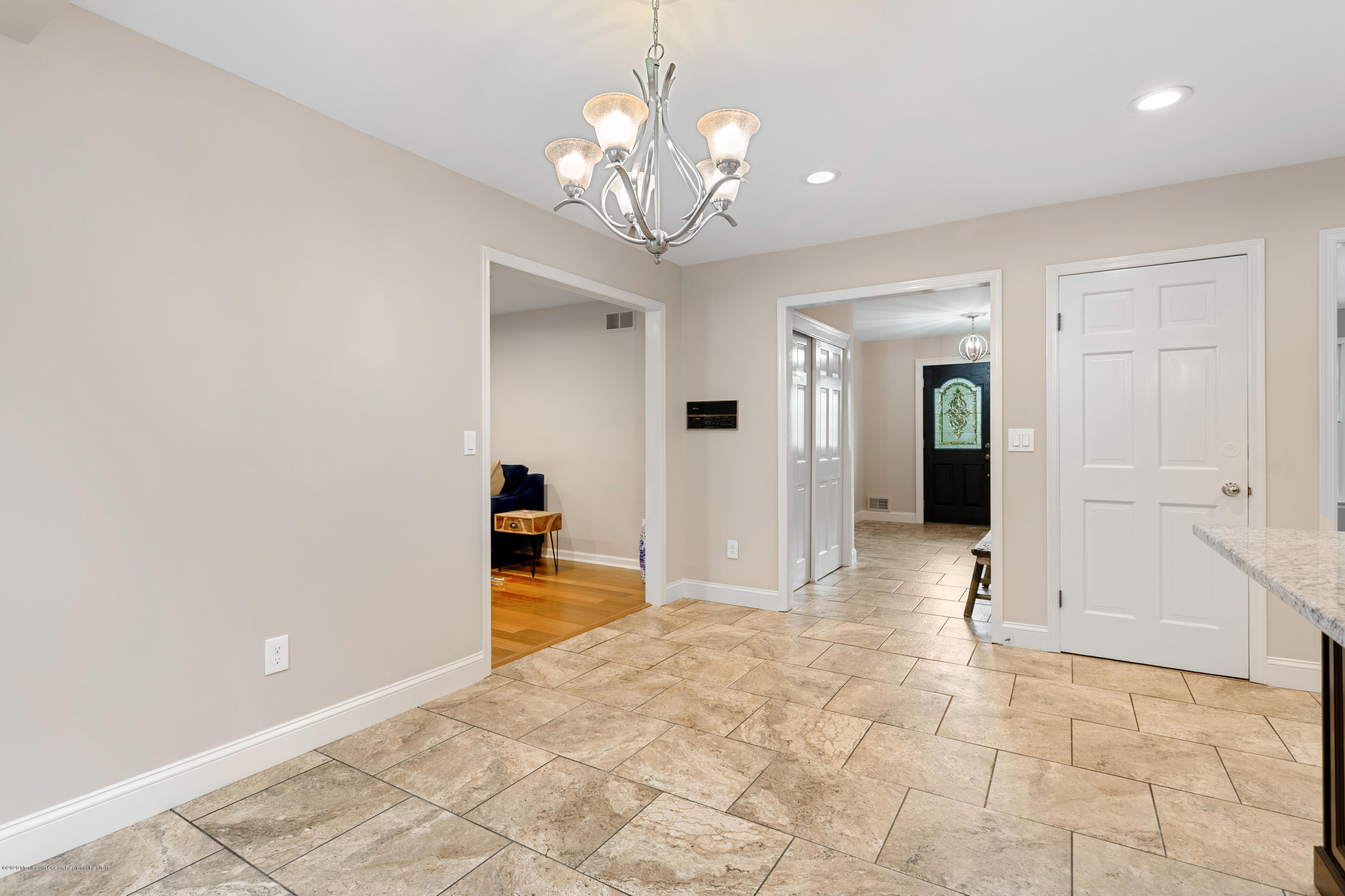 202 Adelphia Road Farmingdale, NJ 07727 - Photo 12 of 40 a view of a hallway with wooden floor and chandelier