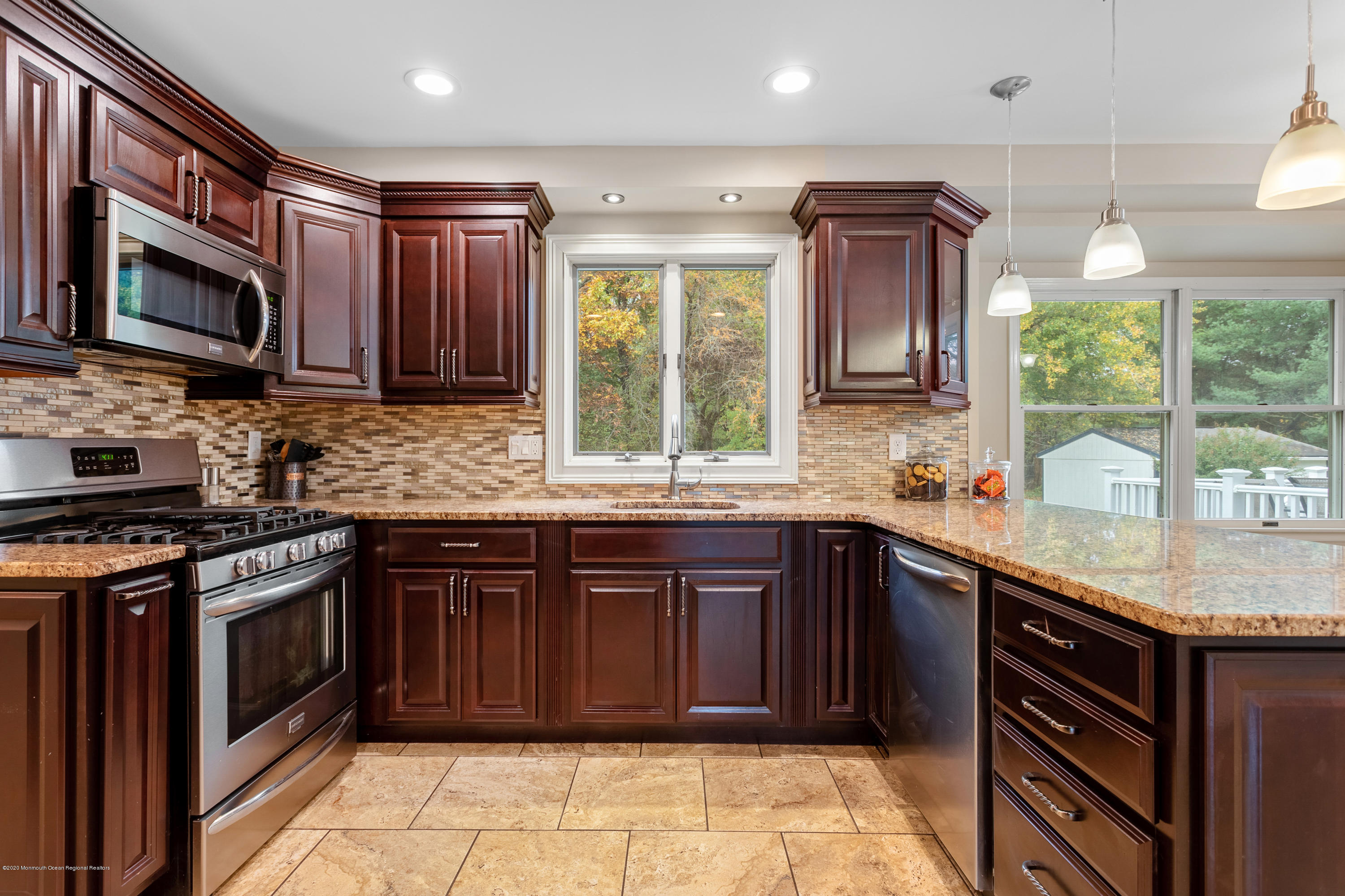 202 Adelphia Road Farmingdale, NJ 07727 - Photo 14 of 40 a kitchen with stainless steel appliances granite countertop a stove sink and microwave