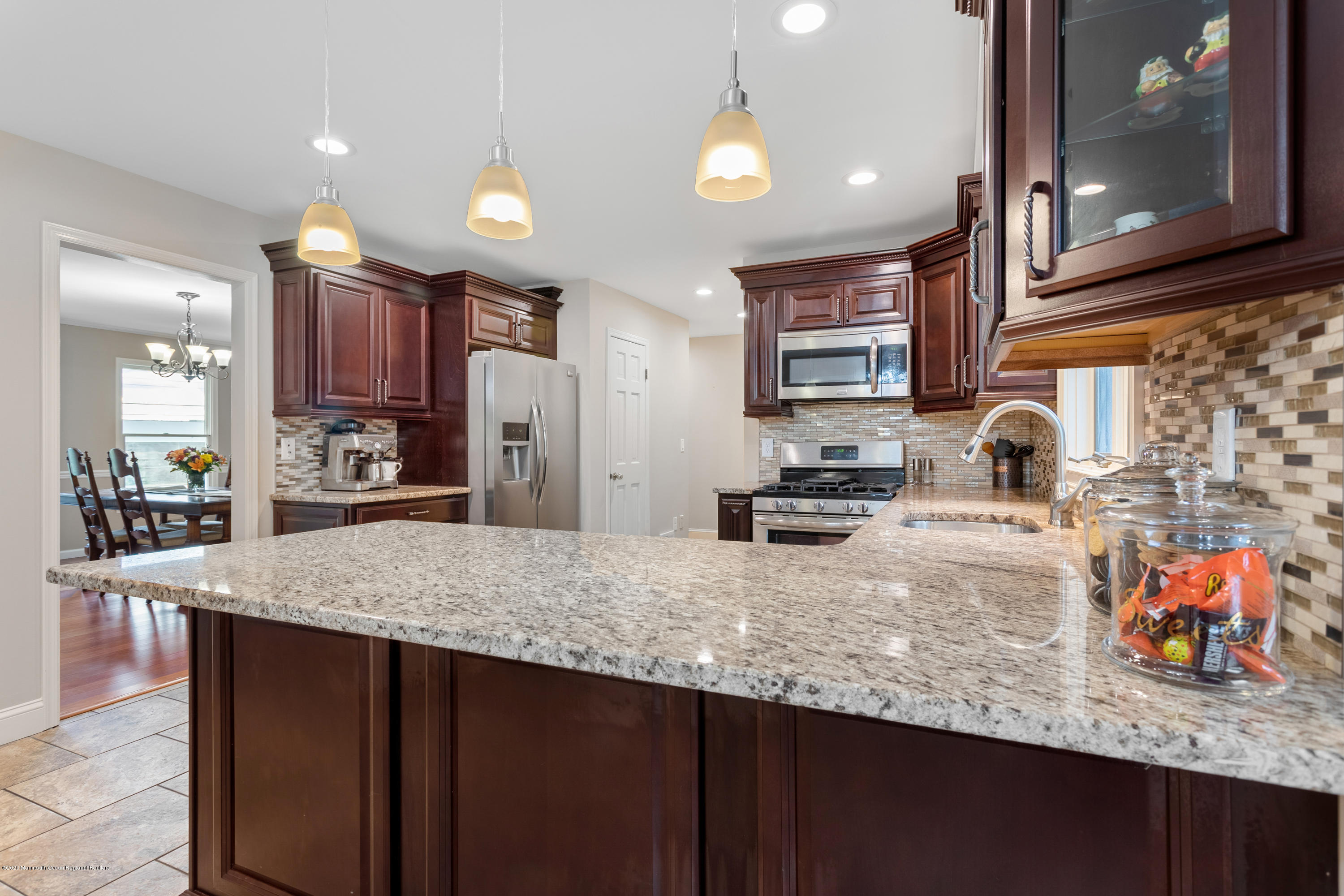 202 Adelphia Road Farmingdale, NJ 07727 - Photo 15 of 40 a kitchen with kitchen island granite countertop wooden cabinets a refrigerator and a sink