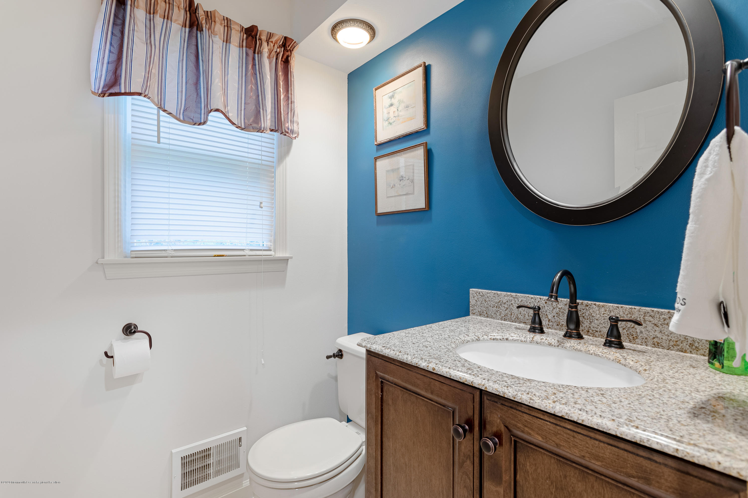 202 Adelphia Road Farmingdale, NJ 07727 - Photo 16 of 40 a bathroom with a granite countertop toilet a sink and a mirror