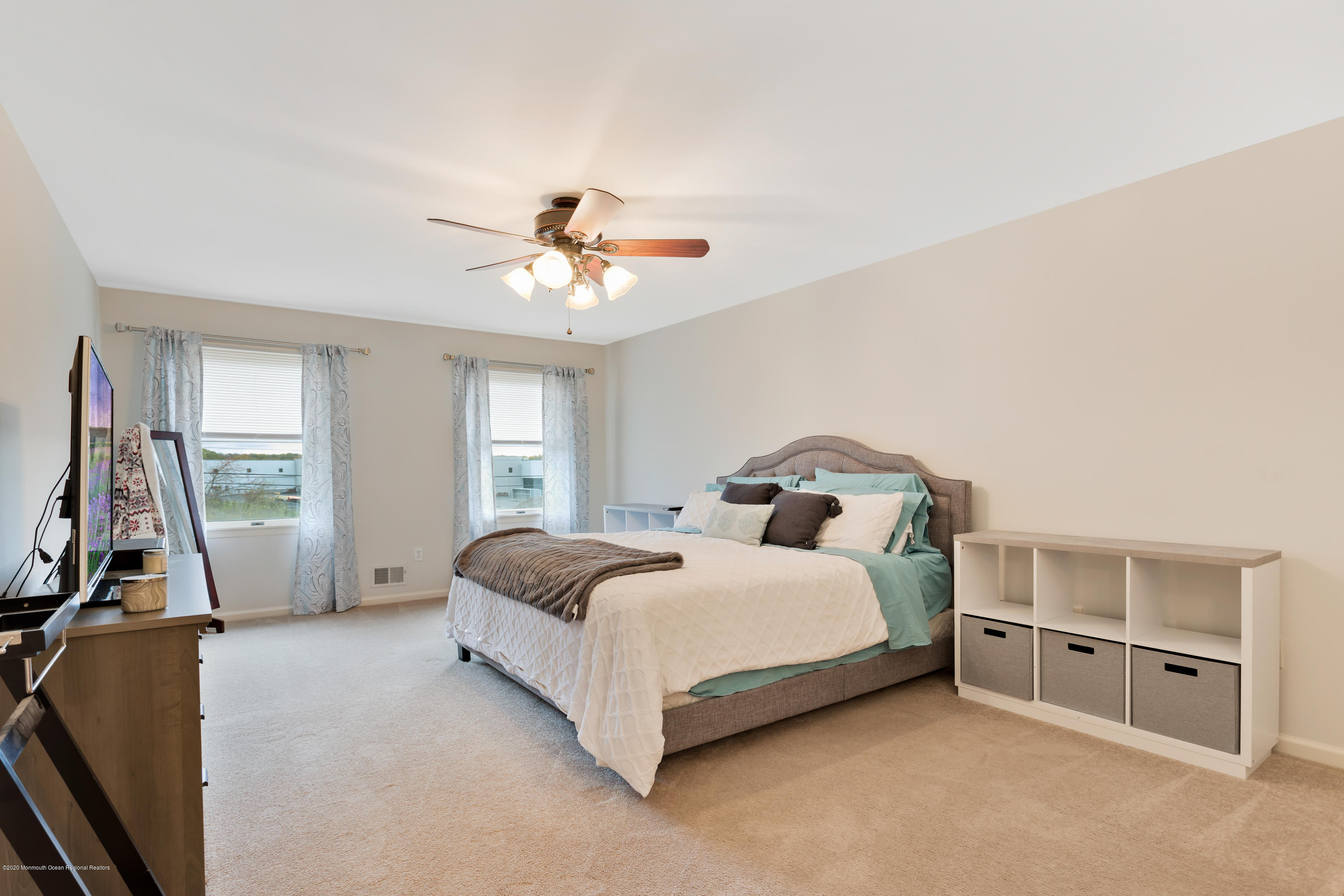 202 Adelphia Road Farmingdale, NJ 07727 - Photo 20 of 40 a spacious bedroom with a bed and a chandelier