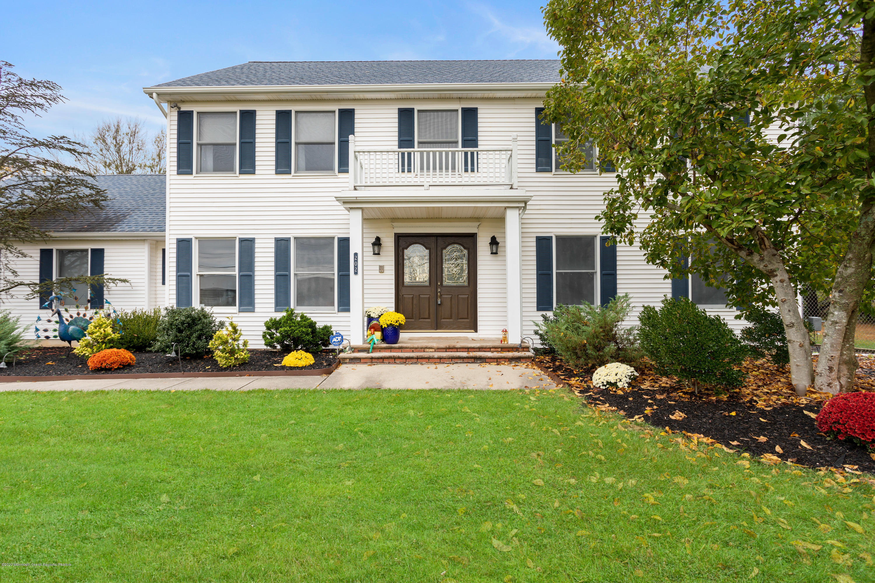 202 Adelphia Road Farmingdale, NJ 07727 - Photo 3 of 40 a front view of a house with garden and porch