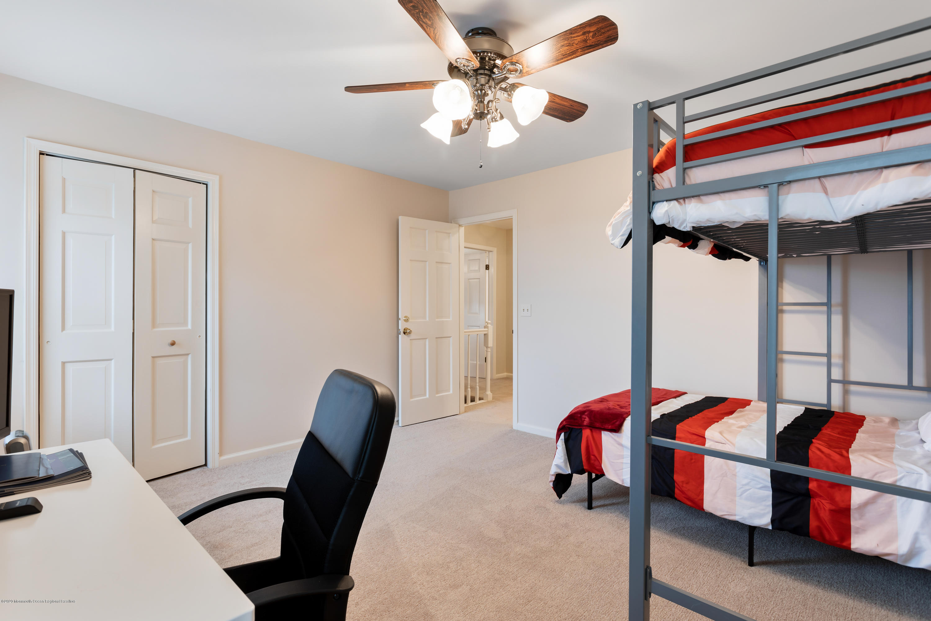 202 Adelphia Road Farmingdale, NJ 07727 - Photo 24 of 40 a bedroom with a bed and a chandelier