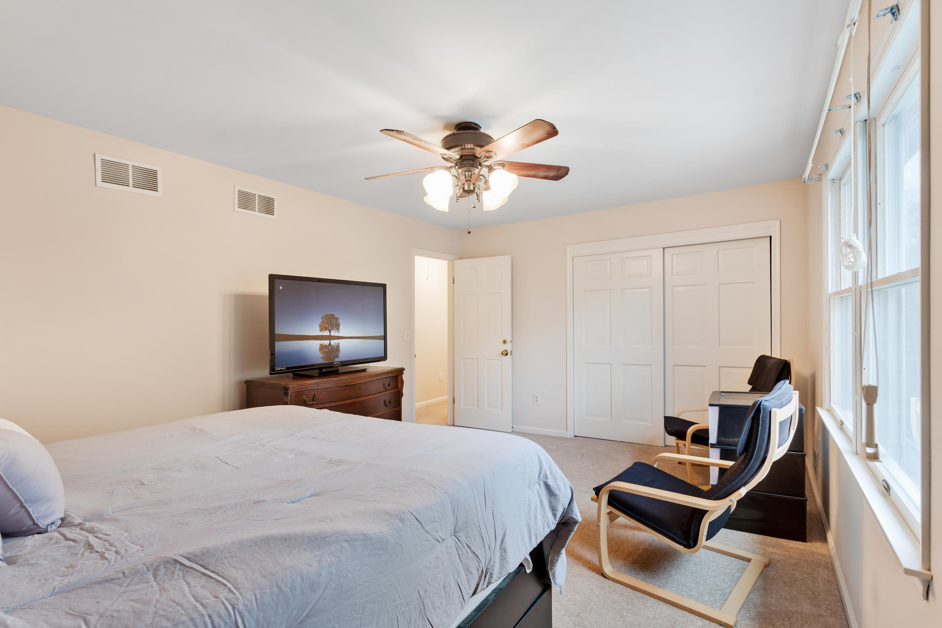 202 Adelphia Road Farmingdale, NJ 07727 - Photo 26 of 40 a bedroom with a bed and a chandelier