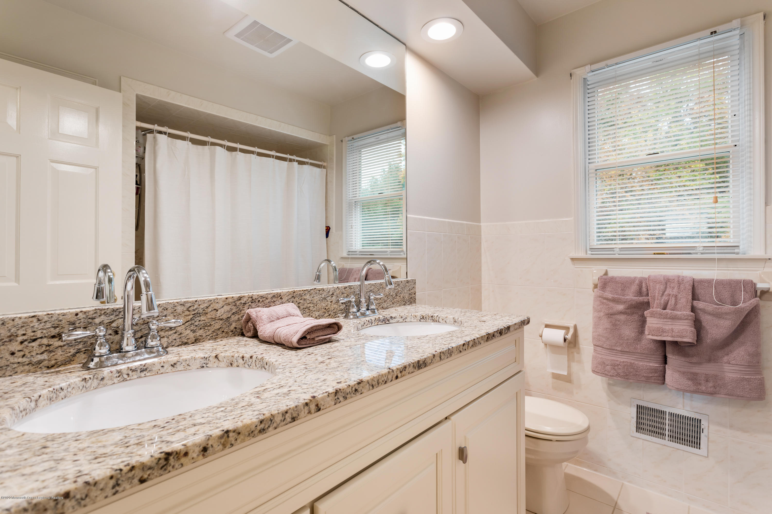 202 Adelphia Road Farmingdale, NJ 07727 - Photo 29 of 40 a bathroom with a granite countertop sink and a mirror