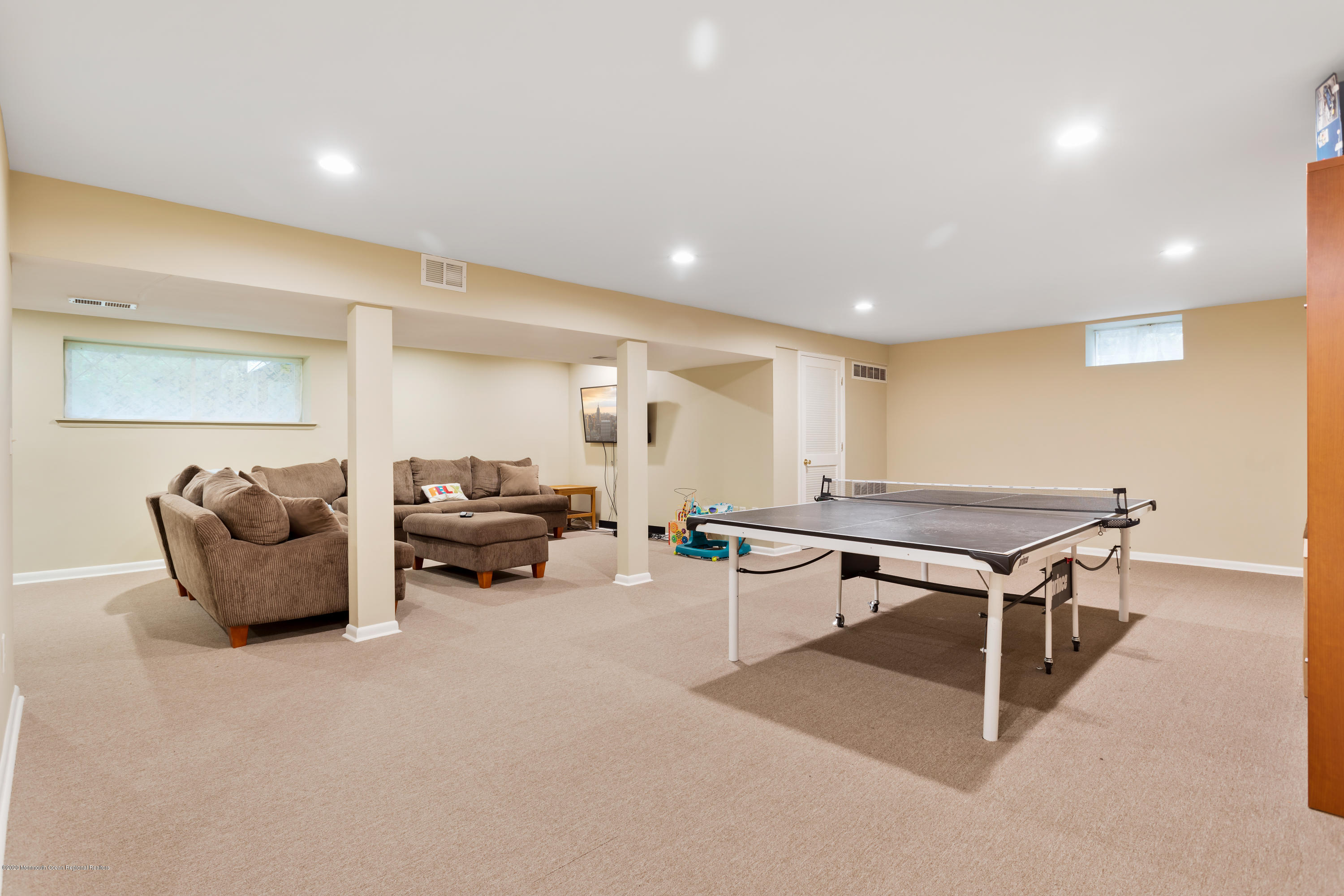 202 Adelphia Road Farmingdale, NJ 07727 - Photo 31 of 40 a living room with furniture a table and a flat screen tv