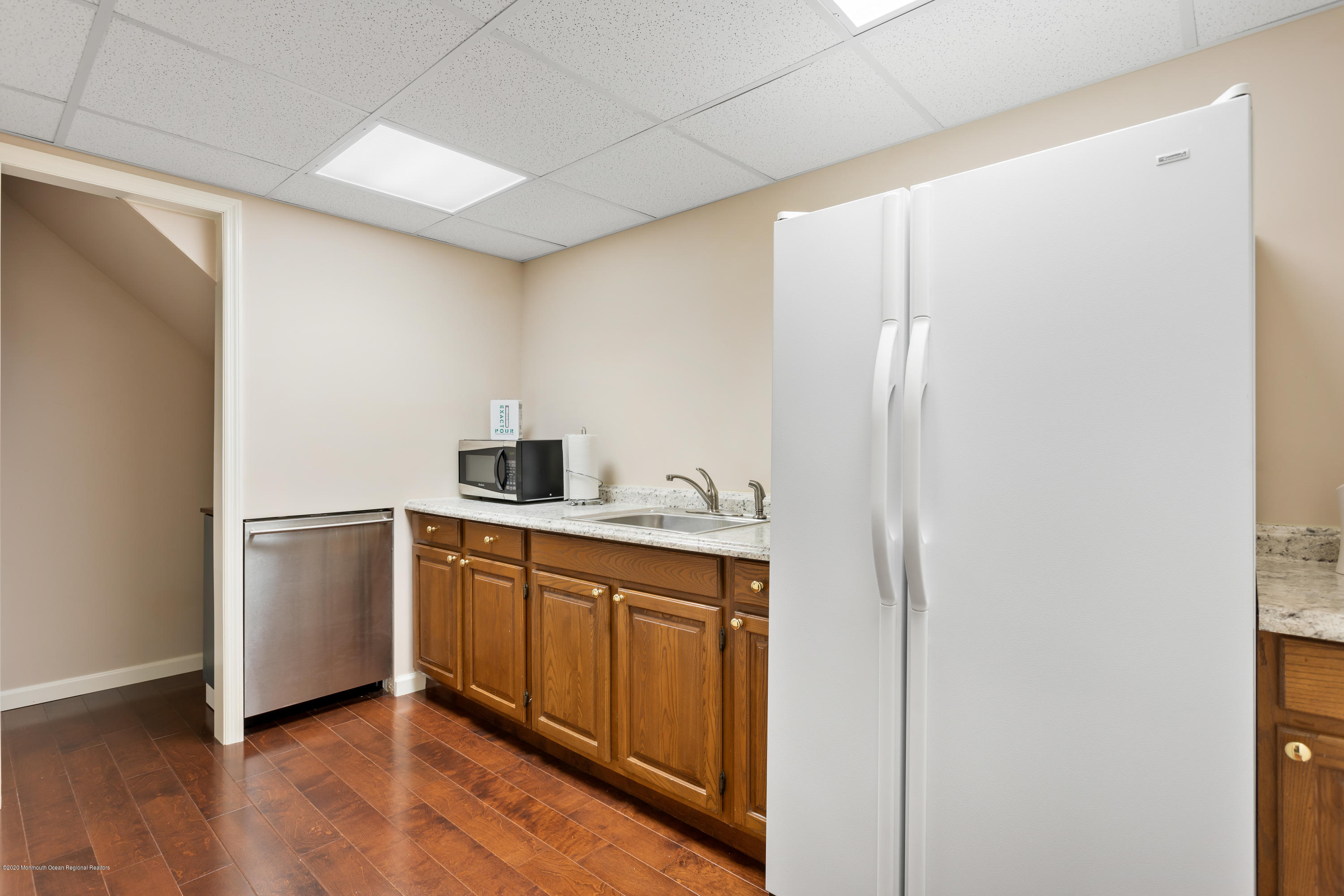 202 Adelphia Road Farmingdale, NJ 07727 - Photo 36 of 40 a kitchen with a refrigerator and cabinets